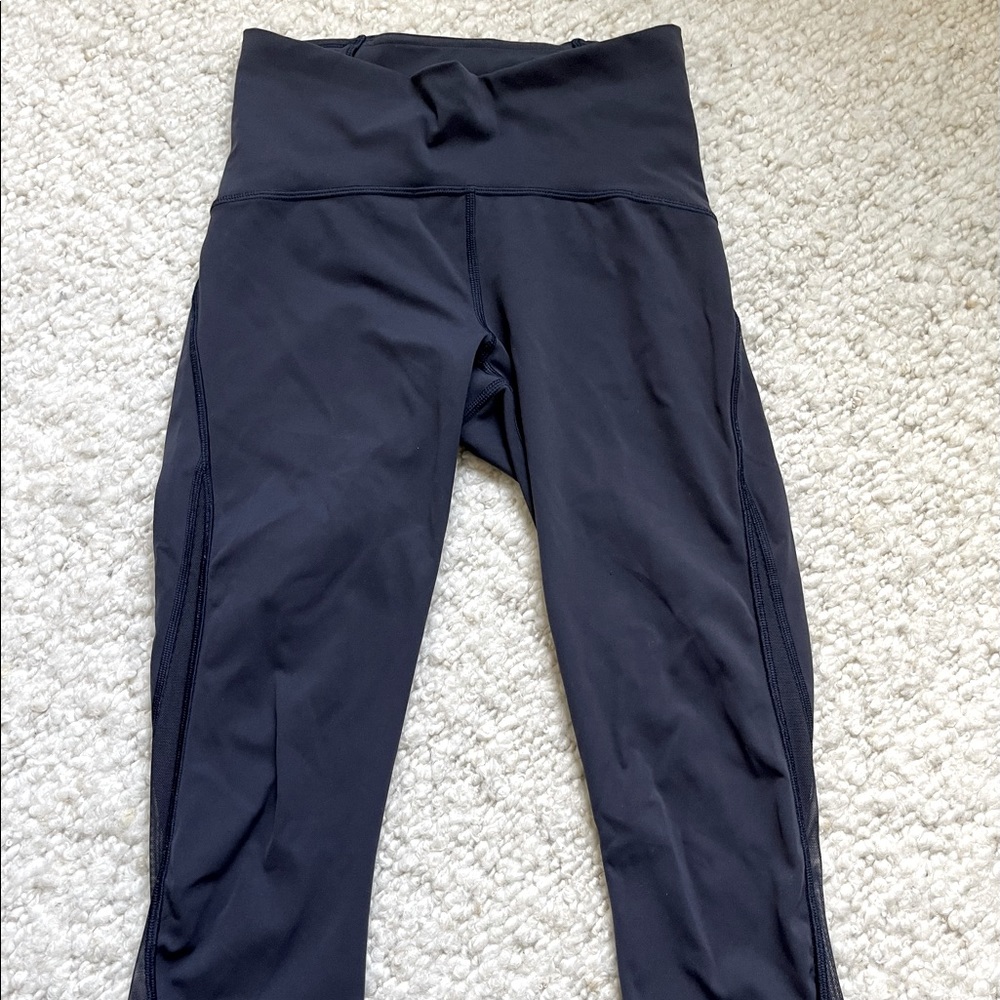 Lulu lemon navy cropped workout leggings with mesh panel on caves. Size 2.